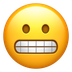 Bagaimana Grimacing Face emoji terlihat di Apple.