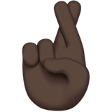 How Crossed Fingers: Dark Skin Tone emoji looks on Apple.