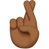 How Crossed Fingers: Medium-Dark Skin Tone emoji looks on Apple.