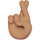 How Crossed Fingers: Medium Skin Tone emoji looks on Apple.