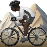 How Person Mountain Biking: Dark Skin Tone emoji looks on Apple.