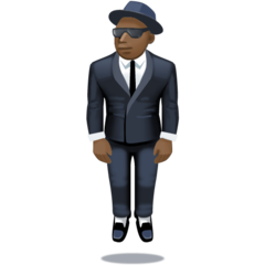 Bagaimana Person in Suit Levitating: Dark Skin Tone emoji terlihat di Facebook.