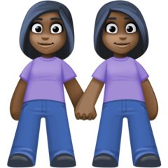 How Women Holding Hands: Dark Skin Tone emoji looks on Facebook.