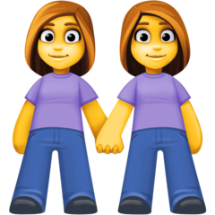 Bagaimana Women Holding Hands emoji terlihat di Facebook.