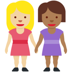 A quoi ressemblent les emoji Deux femmes se tenant la main: peau moyennement claire et peau mate sur Twitter.